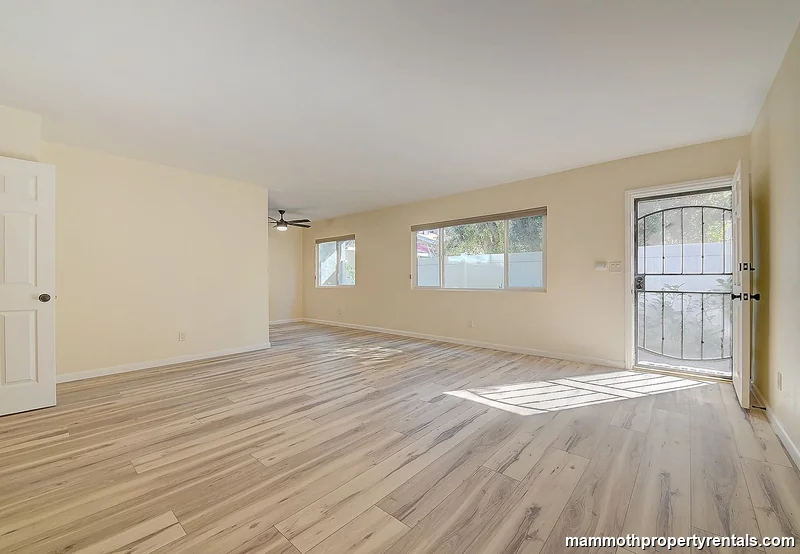 Spacious living and dining area with abundant natural light and hardwood-style floors.