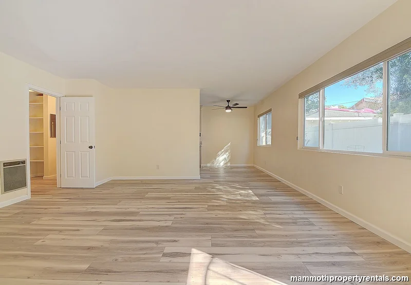 Generous living area with hardwood-style floors, perfect for a work-from-home setup or comfortable midterm stay.