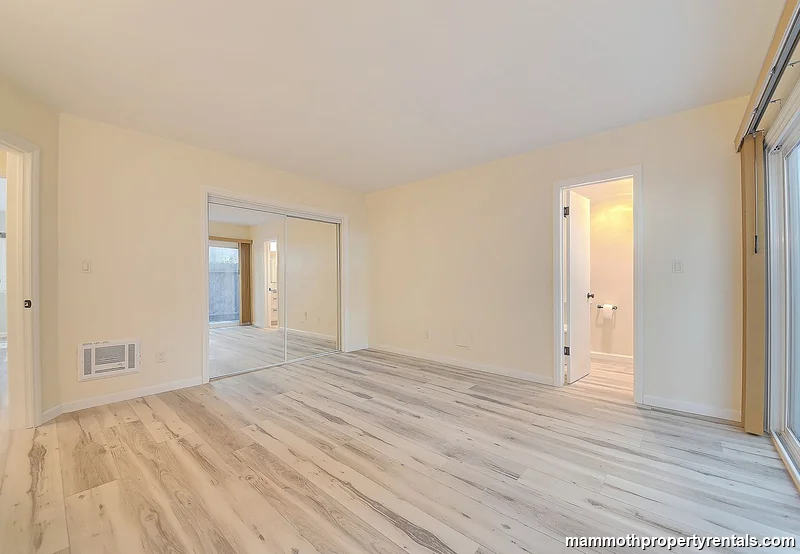 Master bedroom showing closet access and abundant natural light.