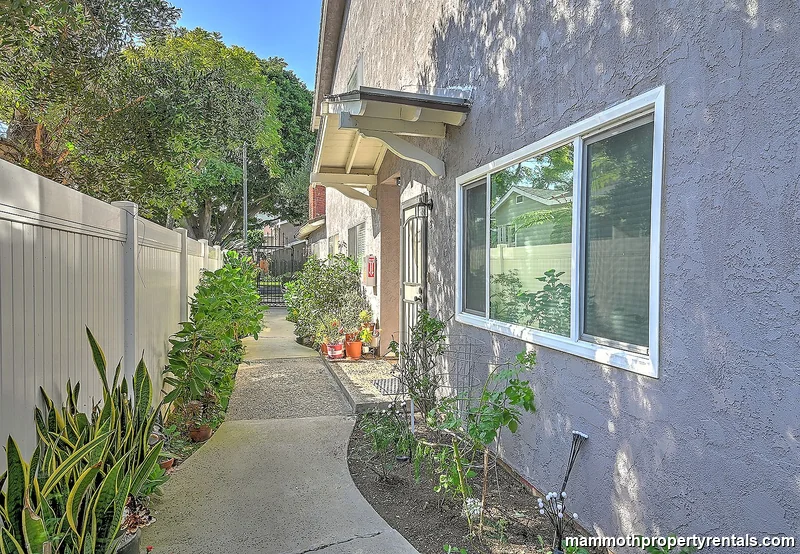 Gated path leading to the front door of Unit 2 - private, secure, and beautifully maintained.